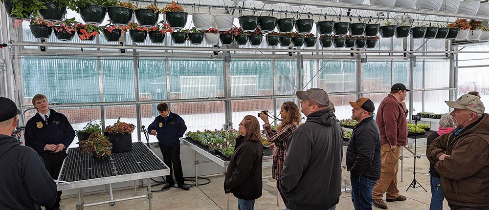Group of people touring a greenhouse